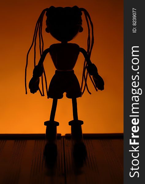 The dark image of a home-made doll