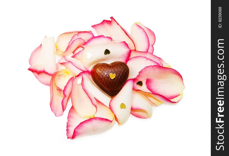 Tender Love - soft focus of heart chocolate on rose petals isolated over white. Clipping path included.