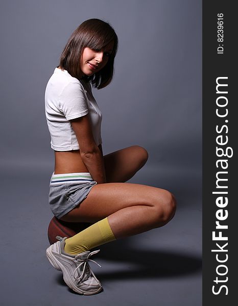 Sportive girl sitting in studio