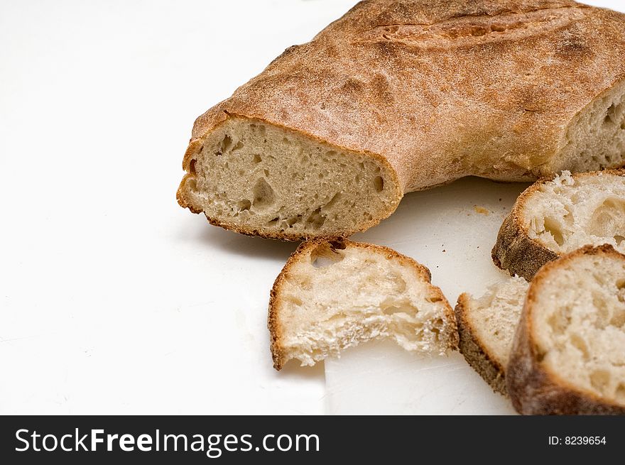 Sliced Italian bread on white background