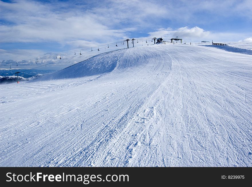 Snow covered mountain with ski lift in the background