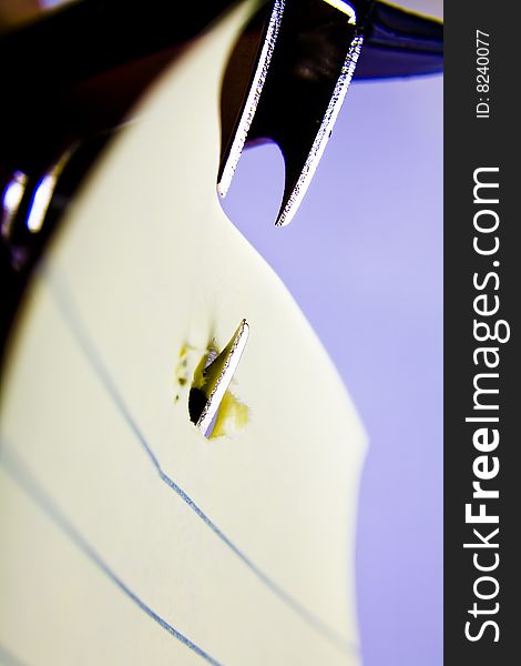 Close up of a Staple remover biting into paper