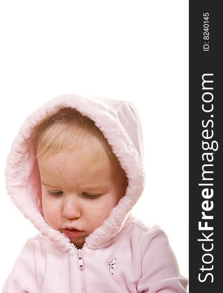 A cute baby in a pink jacket and hood on white. A cute baby in a pink jacket and hood on white