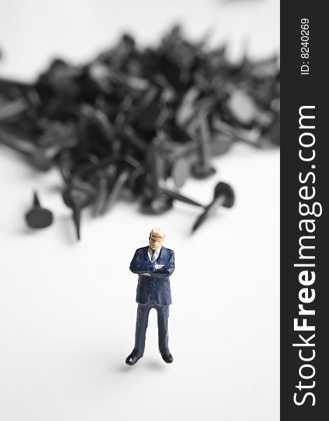 Businessman figurine placed with tacks. Businessman figurine placed with tacks