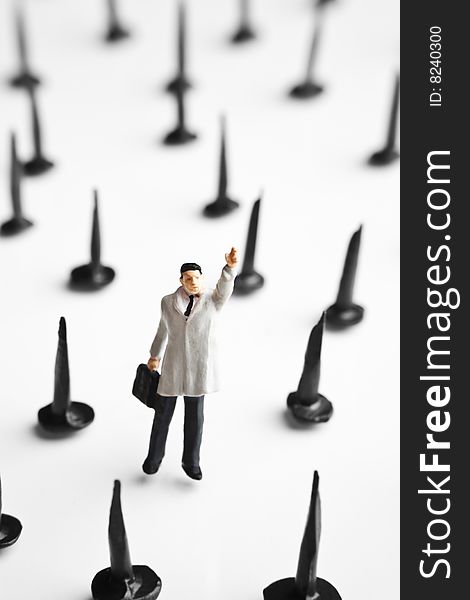 Businessman figurine placed with tacks. Businessman figurine placed with tacks