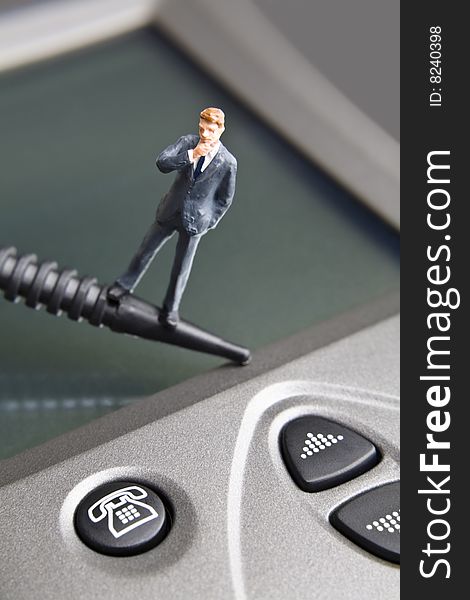 Businessman figurine placed on a PDA. Businessman figurine placed on a PDA