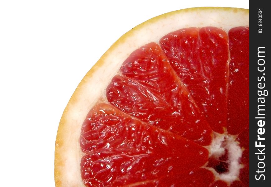 A grapefruit slice over a white background. A grapefruit slice over a white background