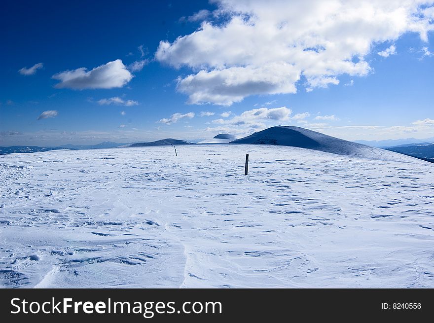 Snow covered mountain with cloudy and blue sky. Snow covered mountain with cloudy and blue sky