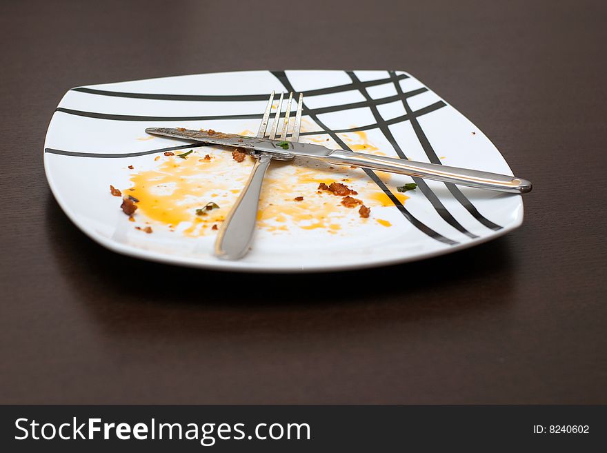 Plate after dinner with fork and knife. Plate after dinner with fork and knife