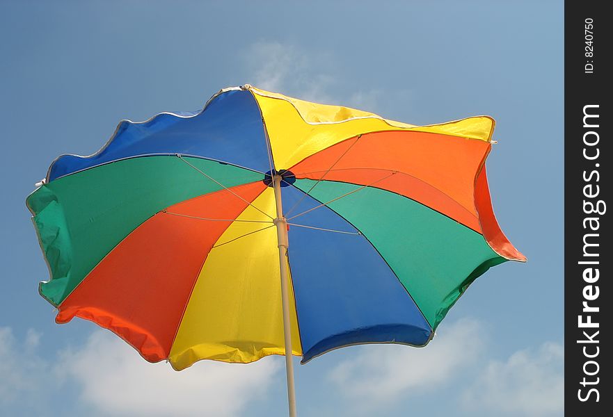 Beach umbrella on a background of the sky