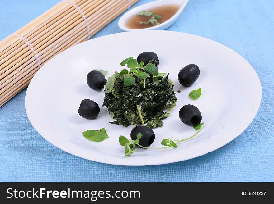 Spinach with black olives