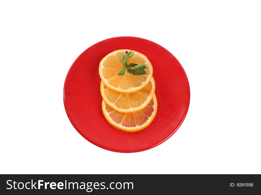 Three slice of orange and peppermint stem on a red plate isolated on white