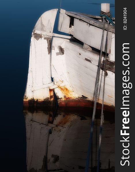 Old wooden boat, refurbishment object, blue stationary sea