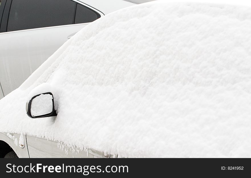 Snow covered the car in the open air car park. Snow covered the car in the open air car park.