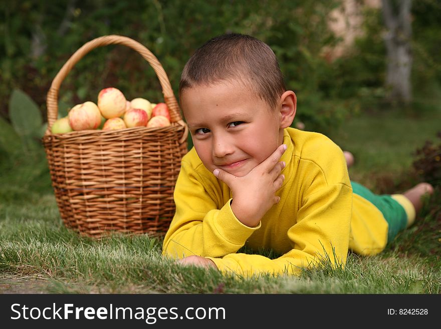 Little boy posing outdoors with apples. Little boy posing outdoors with apples