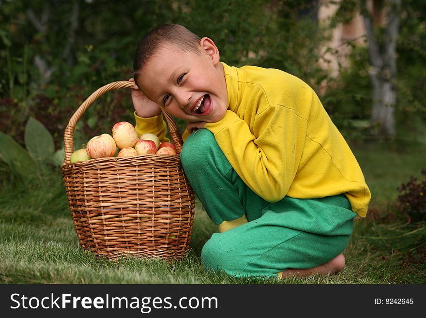 Little boy posing outdoors with apples. Little boy posing outdoors with apples