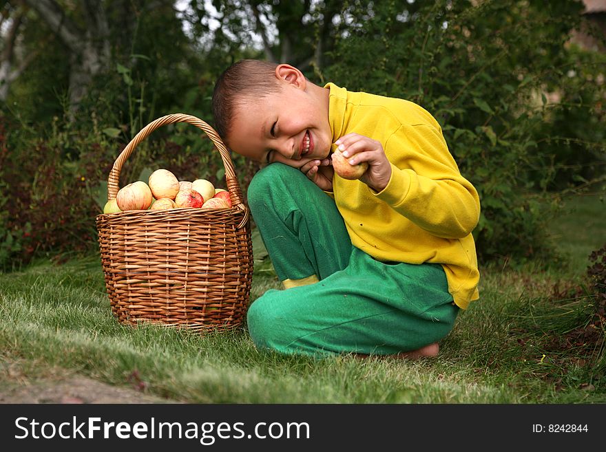 Boy with apples outdoors in summer