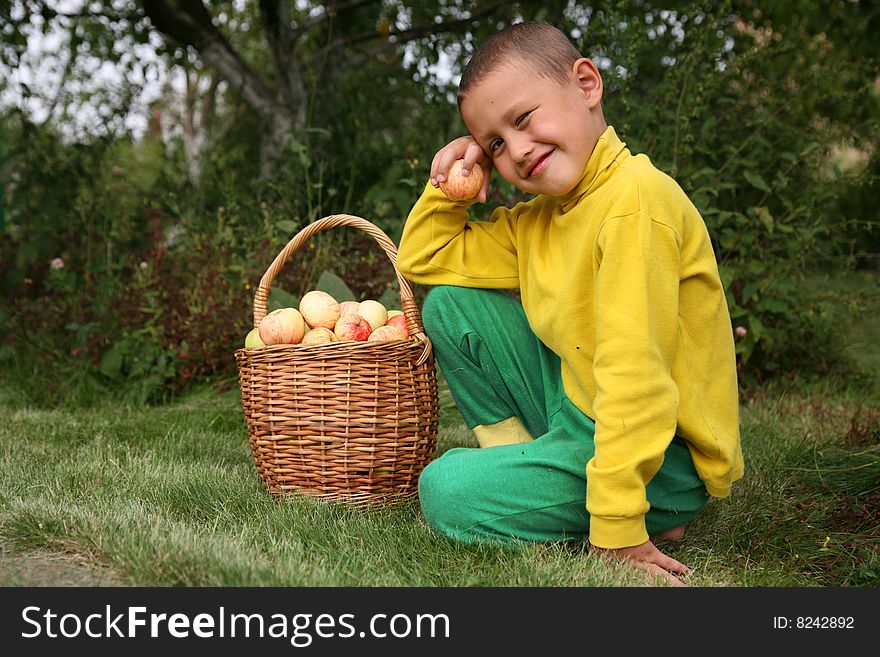 Little boy posing outdoors with apples. Little boy posing outdoors with apples