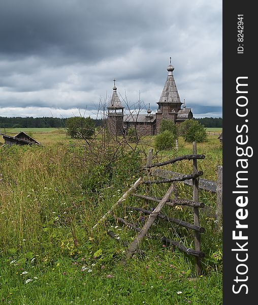 Ancient wooden russian church, storm-clouds in sky