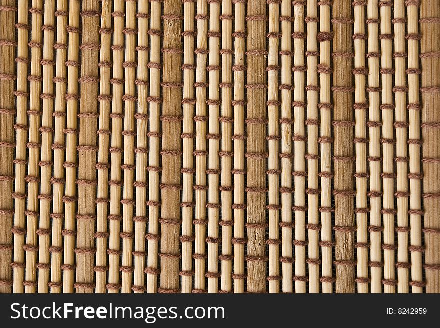Woven background. Mat made out of bamboo pieces. Woven background. Mat made out of bamboo pieces