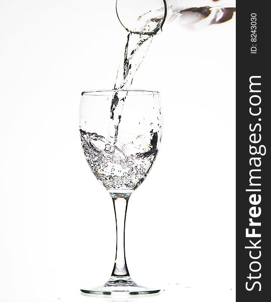 Glass with Splashing water. Coolness Drink. Glass with Splashing water. Coolness Drink