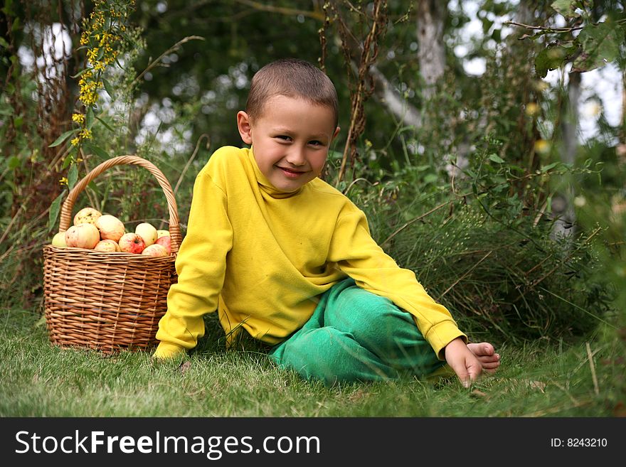 Little boy posing outdoors with apples. Little boy posing outdoors with apples