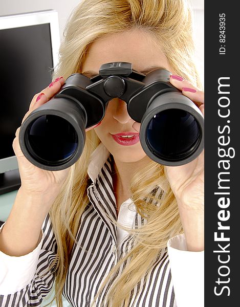 Front view of female looking through binocular in an office