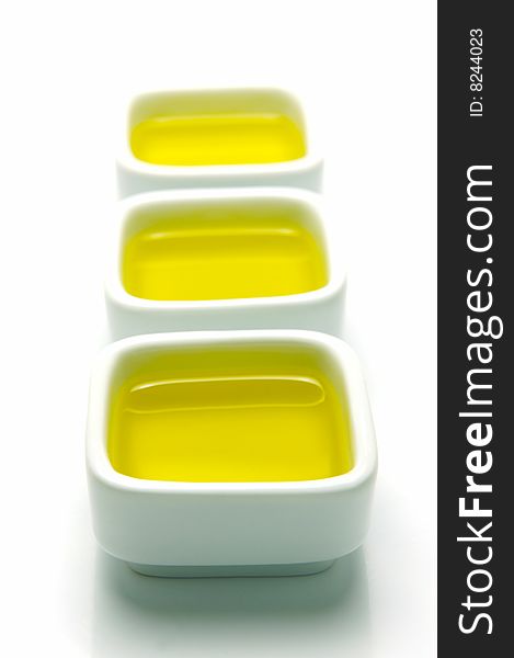 Olive Oil in small serving bowls isolated against a white background