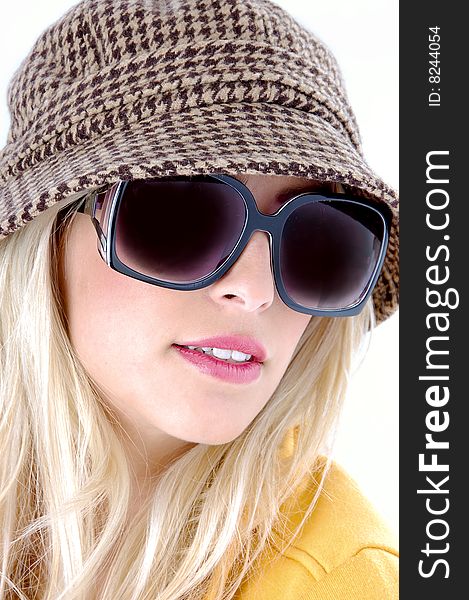 A close up of female wearing sunglasses on an isolated white background