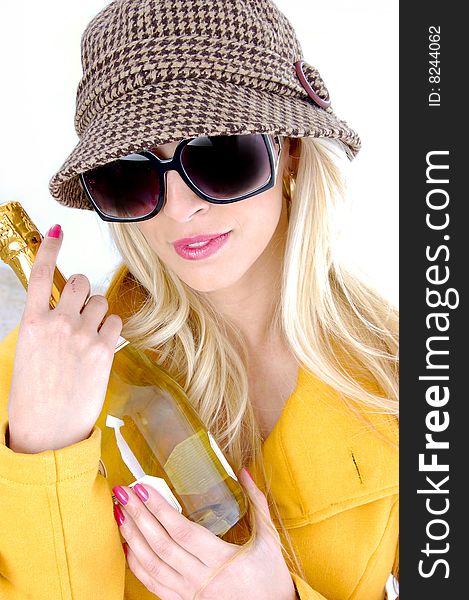 Fashionable woman holding wine bottle