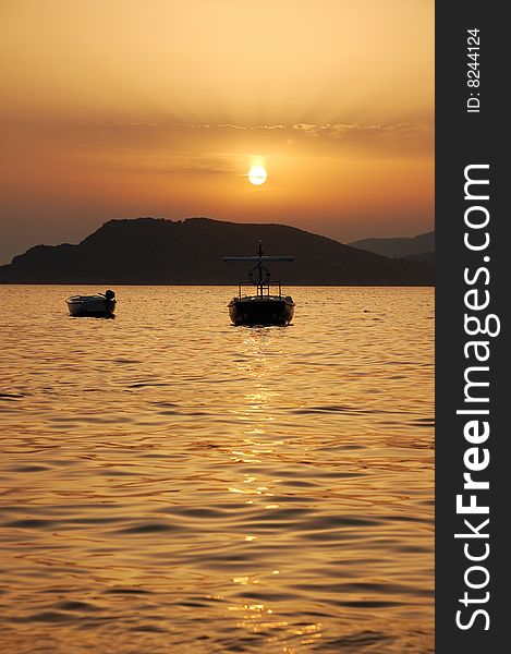 Two boats at sunset. Montenegro. Two boats at sunset. Montenegro