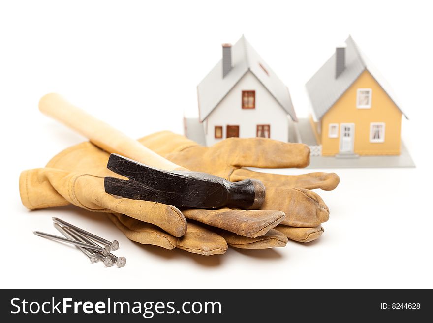 Hammer, Gloves, Nails and House Isolated on a White Background.