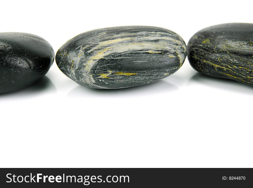 Black river rocks isolated against a white background