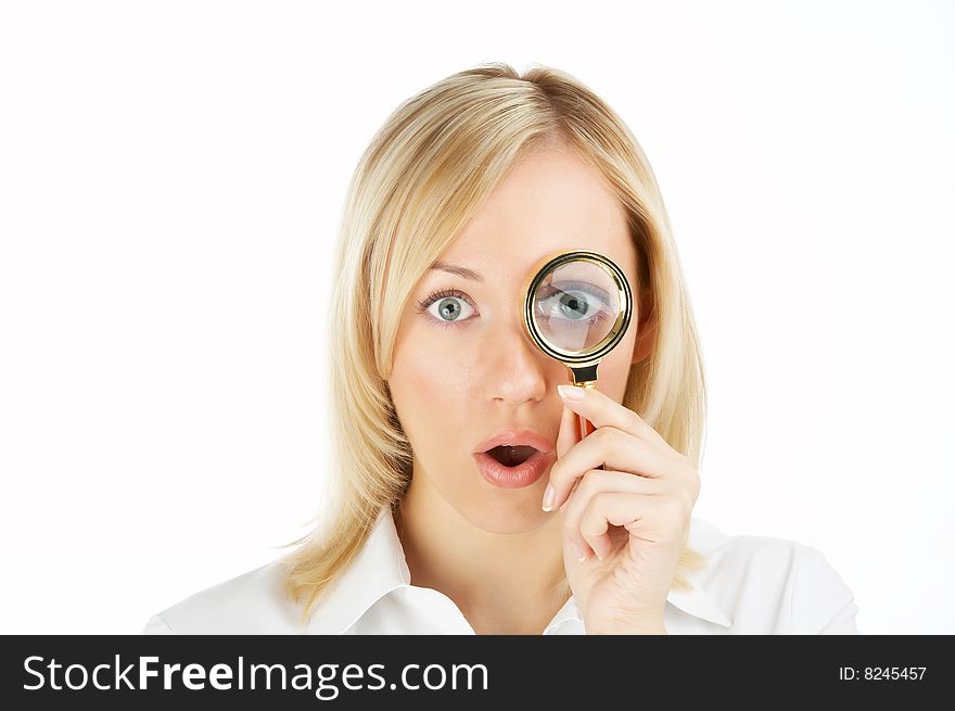 The surprised girl looks in a magnifier, isolated. The surprised girl looks in a magnifier, isolated