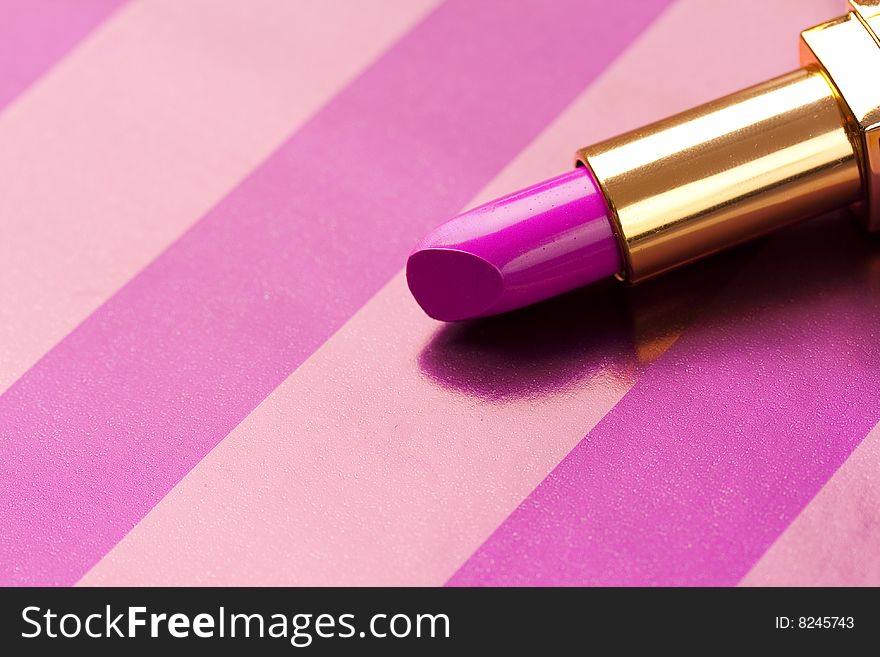 pink lipstick on striped background. pink lipstick on striped background