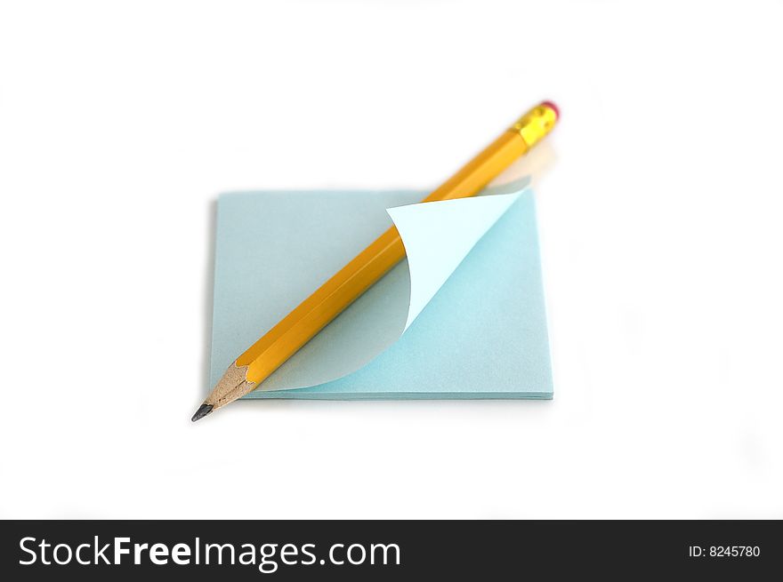 Pencil and note against the white background. Pencil and note against the white background