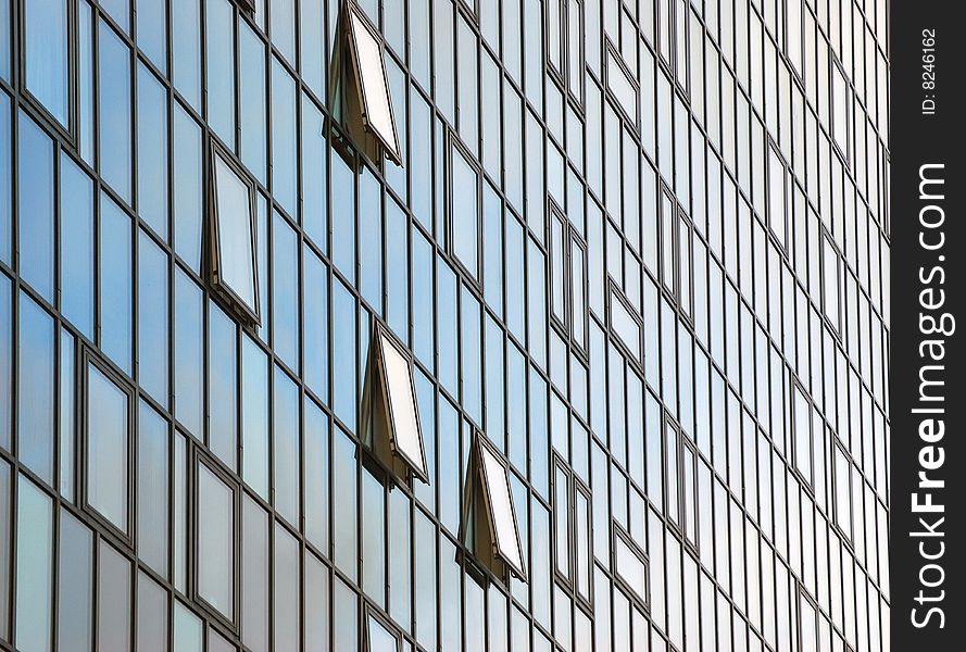 Close-up of glass fronted office block in city