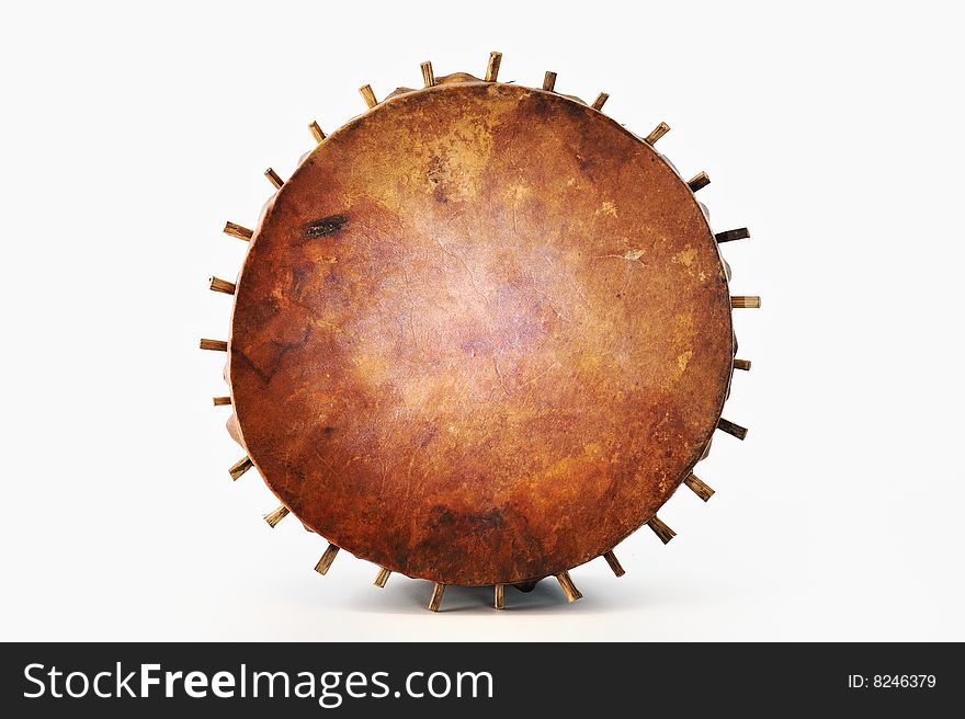 Ancient tambourine from a skin and wood on a white background