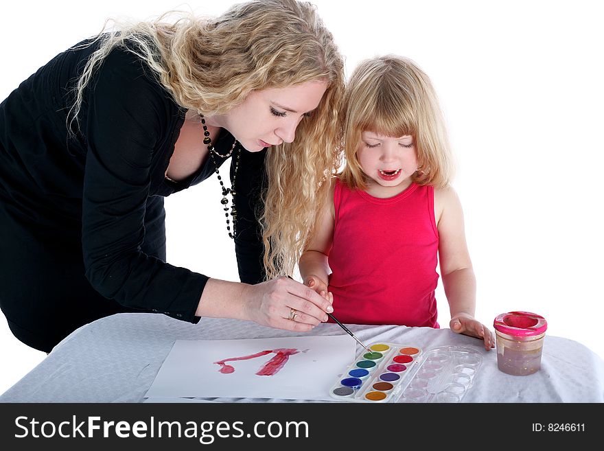 Mom and daughter with paint beside table isolated on white