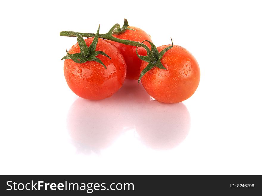 Macroshot of a bunch of tomatoes with drops of water. Isolated over white background. Lot of copyspace. Macroshot of a bunch of tomatoes with drops of water. Isolated over white background. Lot of copyspace.