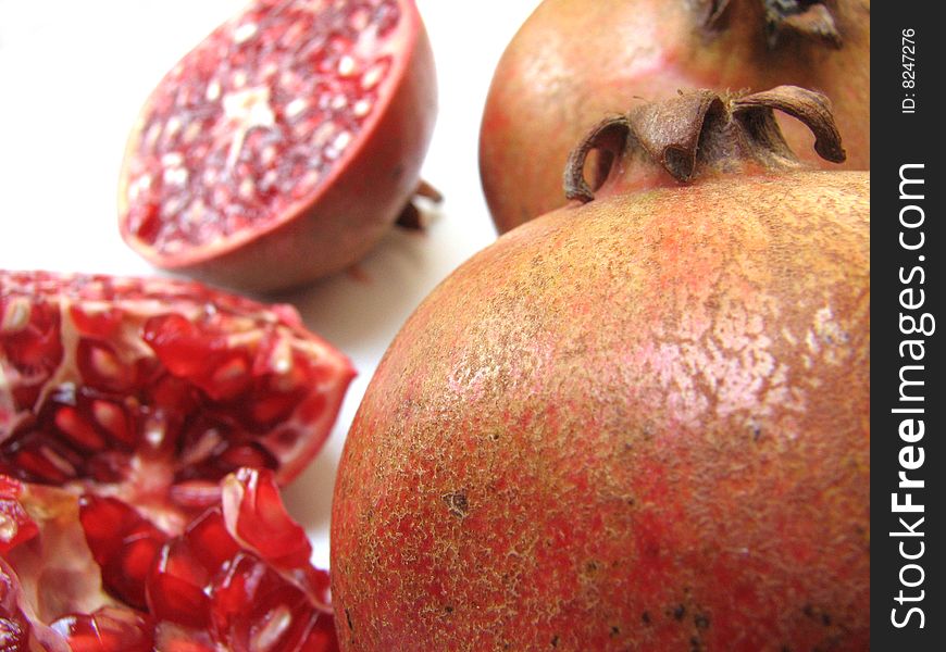 Close-up of Full Pomegranate skin and blur view of half Cut one on white Background. Close-up of Full Pomegranate skin and blur view of half Cut one on white Background