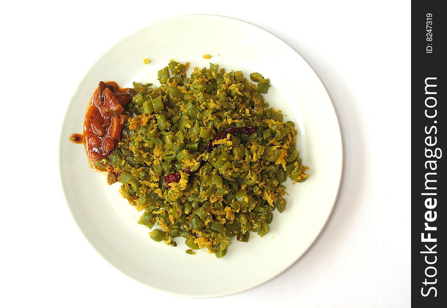 Indian Spicy French Beans Vegetable Dish with Red Mango Pickle in a Round Plate on White Background. Indian Spicy French Beans Vegetable Dish with Red Mango Pickle in a Round Plate on White Background