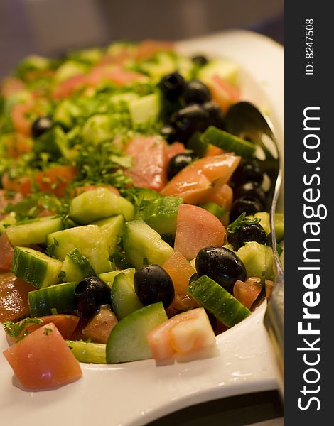 A fresh prepared salad of cucumber and tomatoes. A fresh prepared salad of cucumber and tomatoes