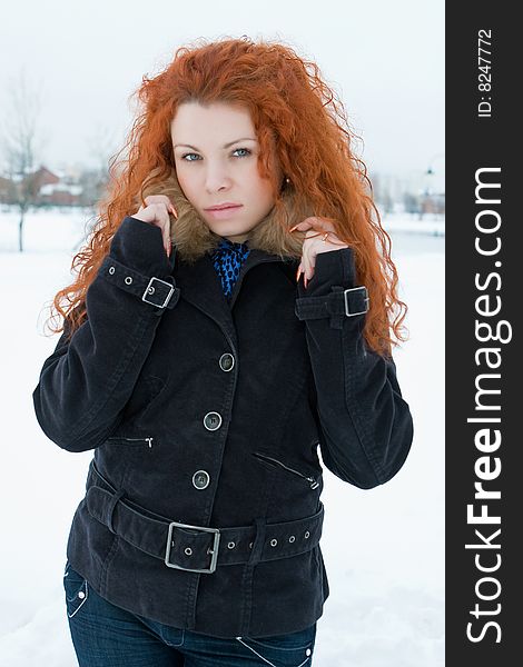 Portrait of the young beautiful woman with red hair