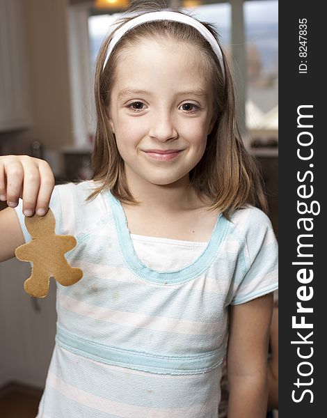Nine year old girl shows her gingerbread cookie. Nine year old girl shows her gingerbread cookie.