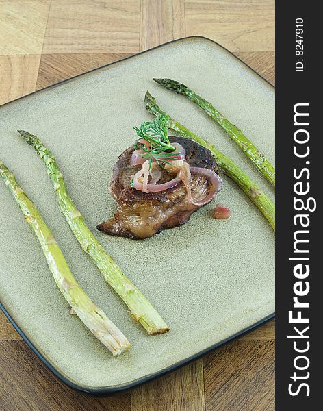 Filet mignon on plate with roasted asparagus