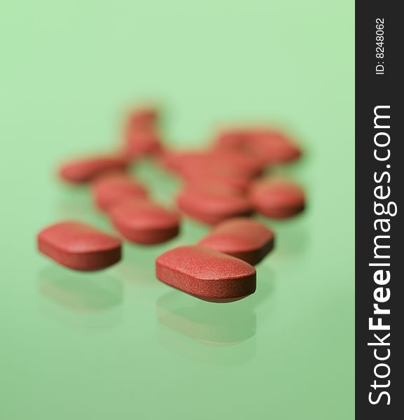 Red pills toward green background