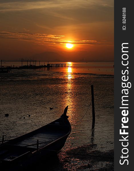 View of golden sunrise at fishing village near coastal.