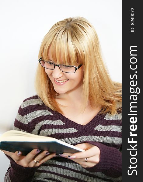 Portrait of a  young lady reading a book and saile  with  cup in hand. . Isolated over white background. Portrait of a  young lady reading a book and saile  with  cup in hand. . Isolated over white background