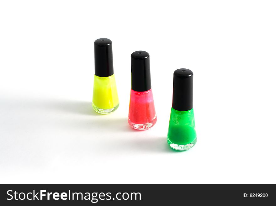 Three vials of the colour varnish for nail on white background